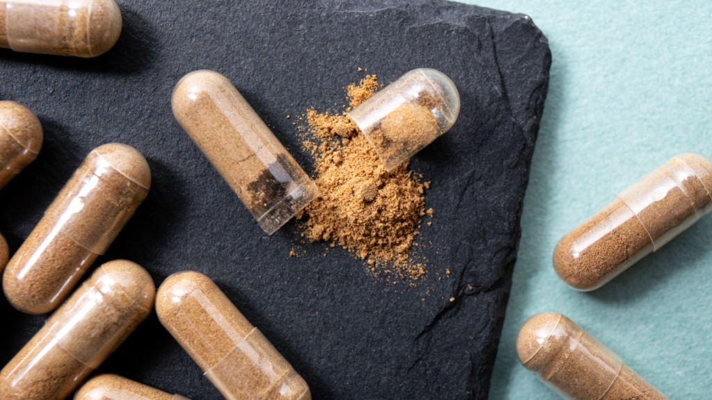 An open capsule shows how mushroom powder settles once it leaves the plate