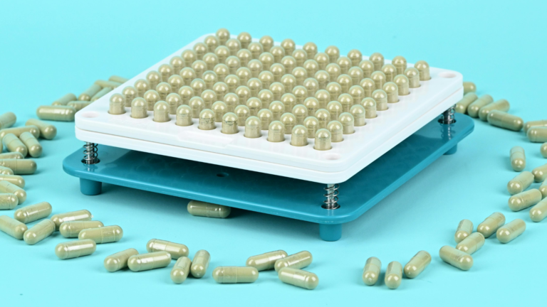 Capsule filling machine tray loaded with capsules for a Canada supplement production run
