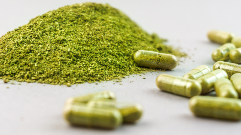 Close-up of kratom powder and empty capsules