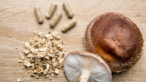 Dried mushroom pieces next to finished capsules show why raw powder texture matters