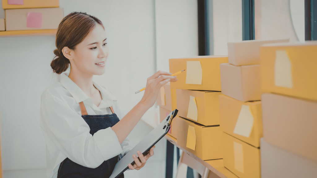Small business owner checking shipped packages after ordering a capsule filling machine in Canada