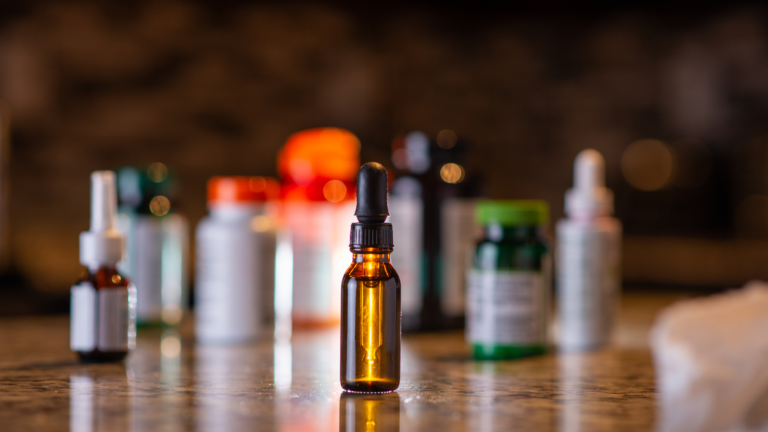 Amber tincture dropper bottle among supplement containers_ representing a liquid capsule filling machine setup.