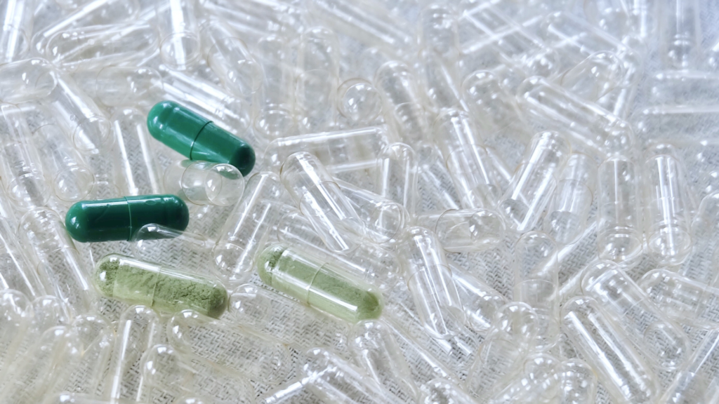 Assorted empty capsules showing color and material variety.