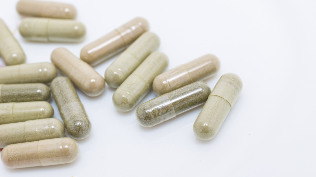 Capsules filled with herbal powder showing natural color variation.