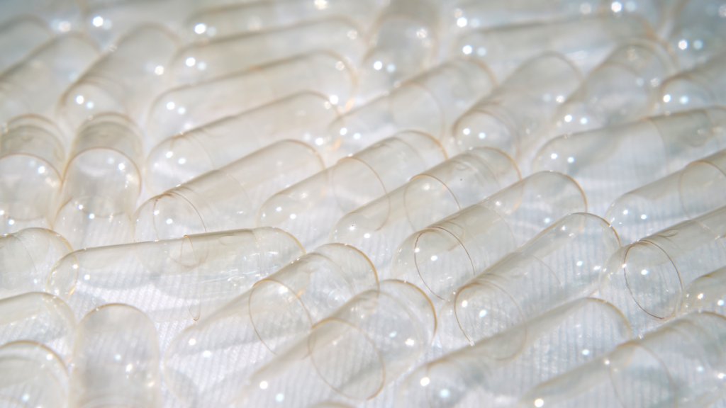 Close-up of empty translucent vegan capsule shells before filling