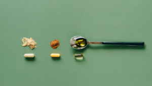 Powder_ herb_ and oil capsule fills shown beside empty capsule shells before filling.