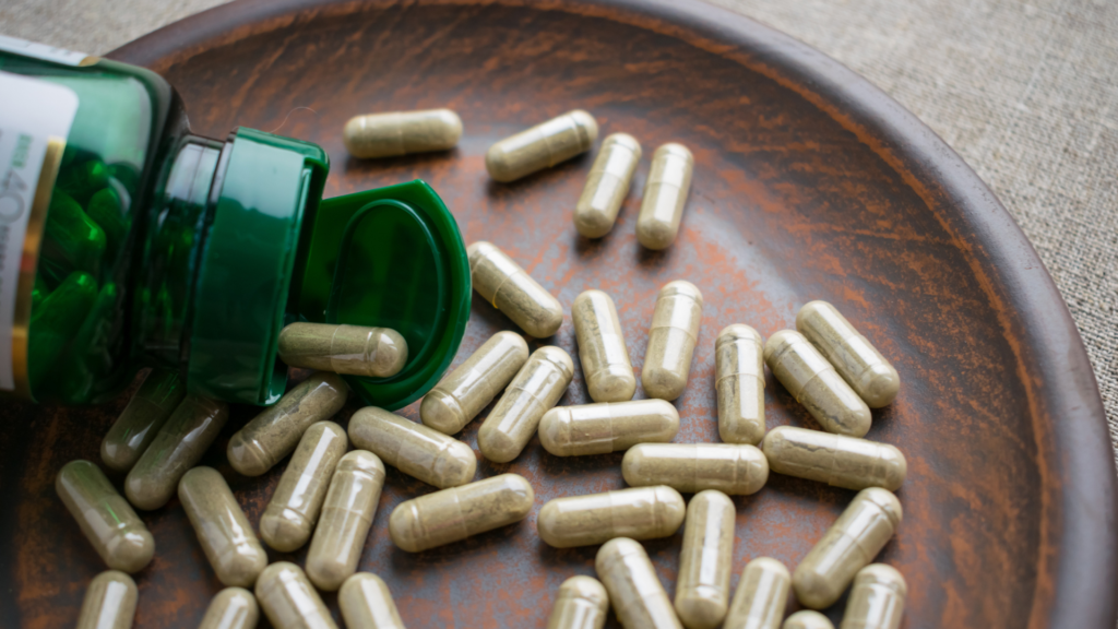 Supplement bottle spilling capsules onto a plate_ representing the cost of pre-made capsules